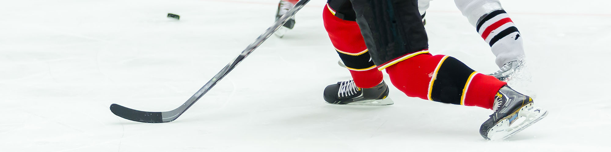 Hockey Player Hitting the Puck